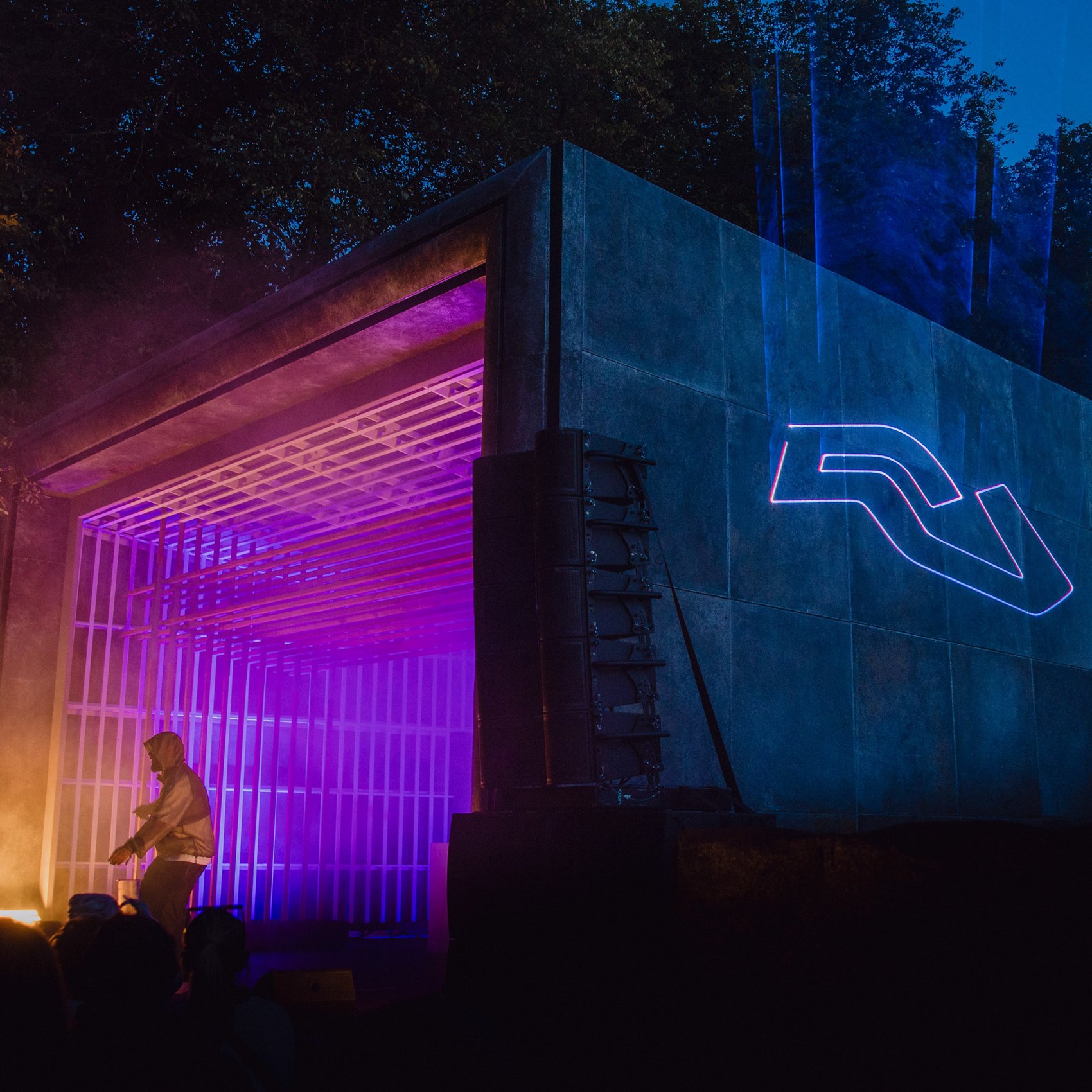 The Resident Advisor logo projected in blue light at a festival
