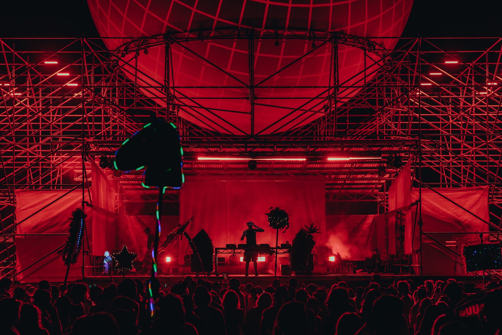 A festival stage lit in red