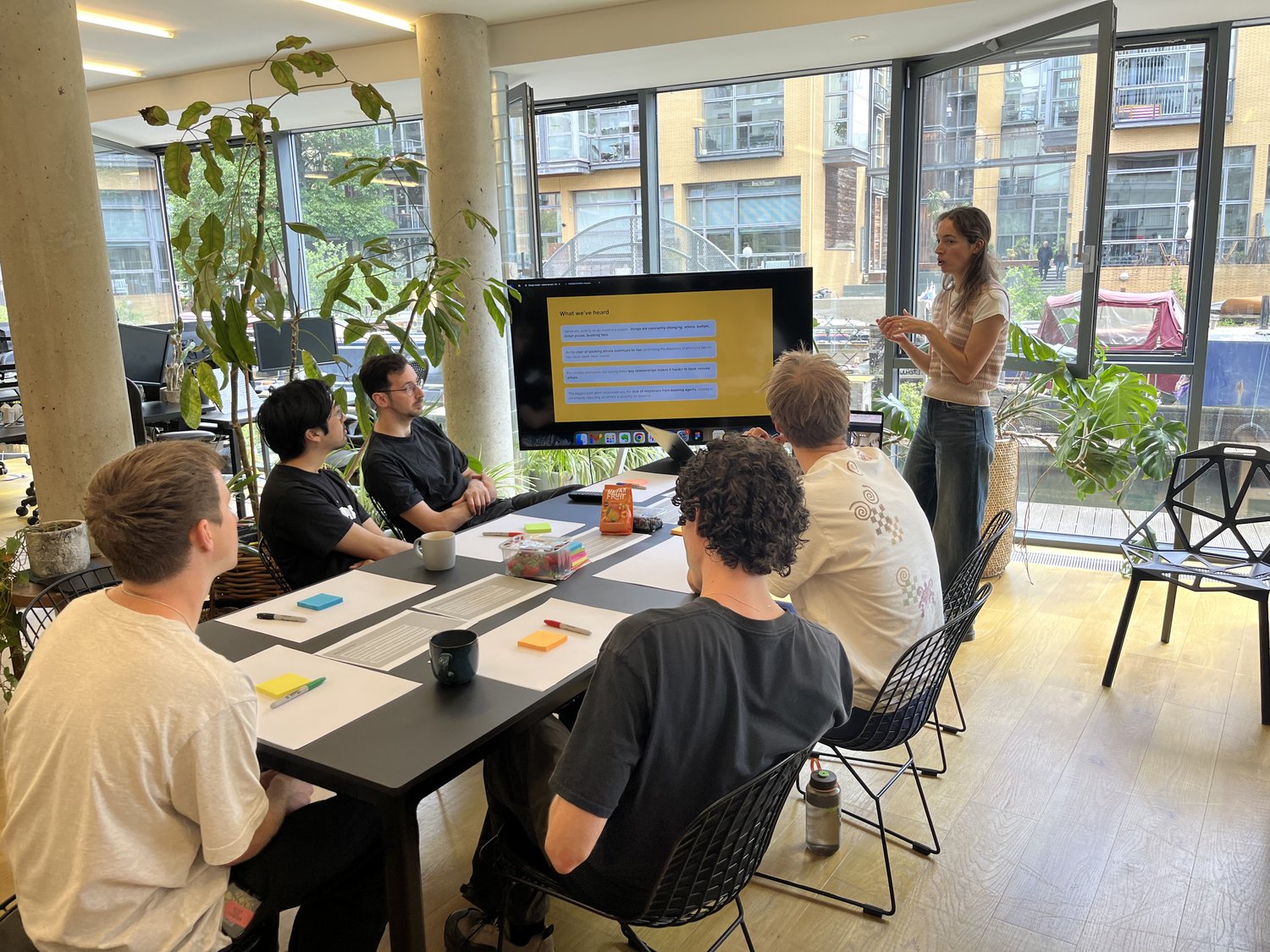 India and the team working through research at a studio table